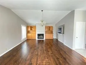 a kitchen with granite countertop a sink a stove and cabinets