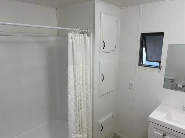 a bathroom with a shower and a sink
