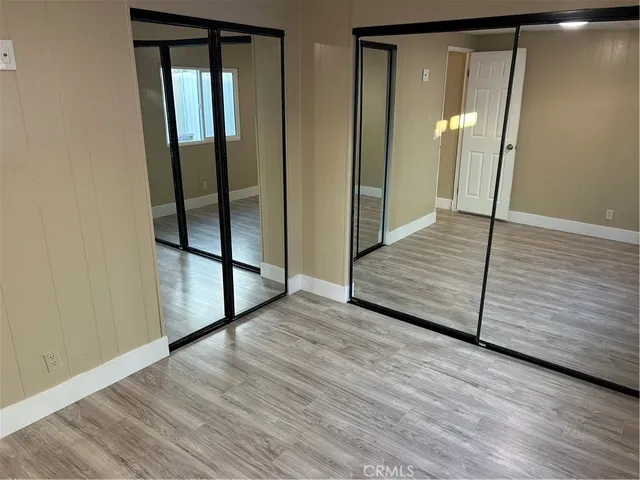 a view of a room with wooden floor and staircase