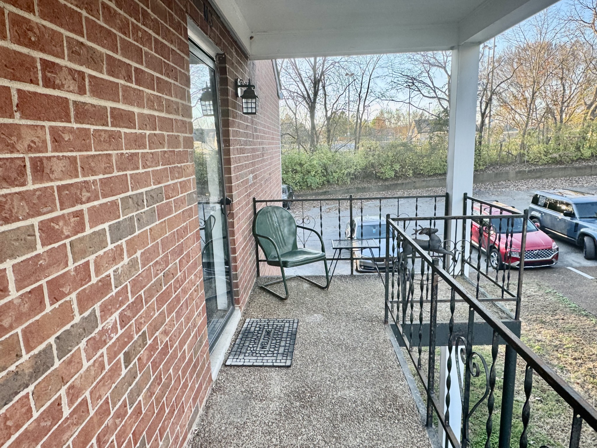 a view of a balcony with chairs and wooden floor