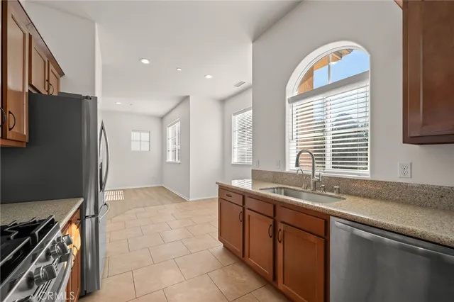 a kitchen with stainless steel appliances granite countertop a sink stove and microwave
