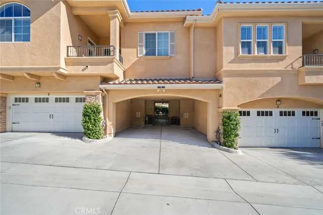 a view of a white house with a yard and garage