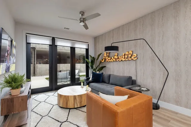 a living room with furniture and a large window