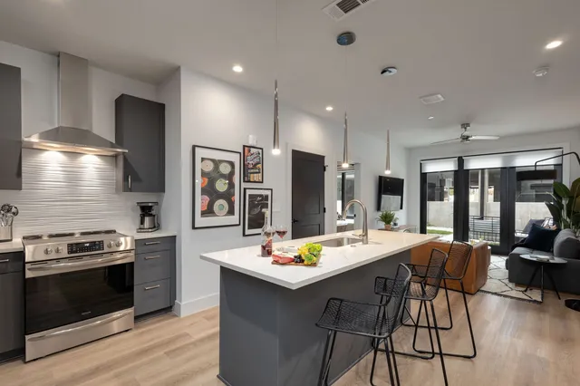 a kitchen with stainless steel appliances granite countertop a stove and a refrigerator