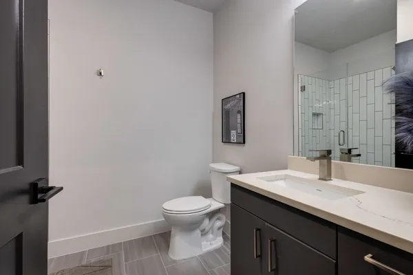 a bedroom with a bed and a lamp on table