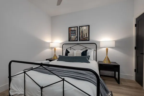 a bedroom with a bed and wooden floor