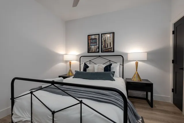 a bedroom with a bed and wooden floor