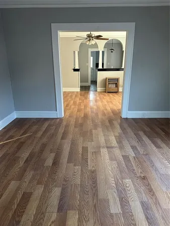 a view of empty room with wooden floor