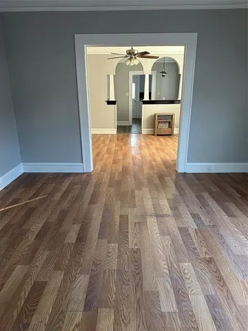 a view of empty room with wooden floor