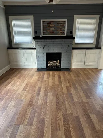 a view of kitchen with microwave and cabinets