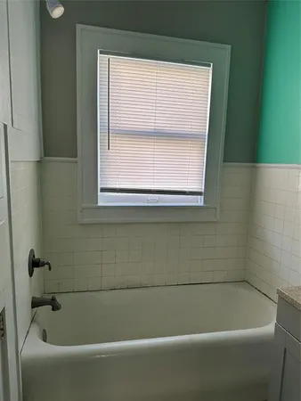 a white bath tub sitting next to a window