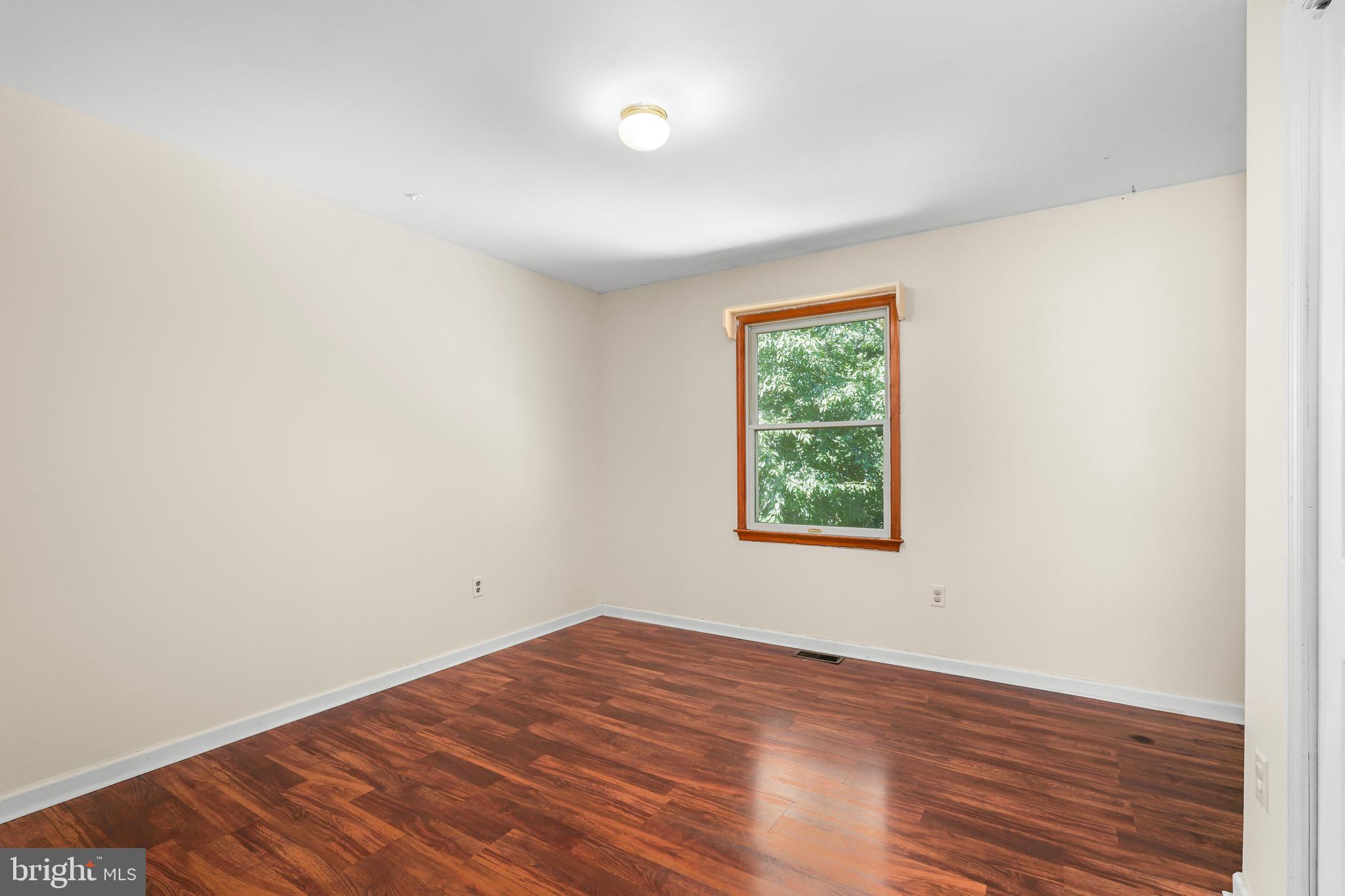 9 Kings Court Elkton, MD 21921 - Photo 15 of 33 an empty room with wooden floor and windows