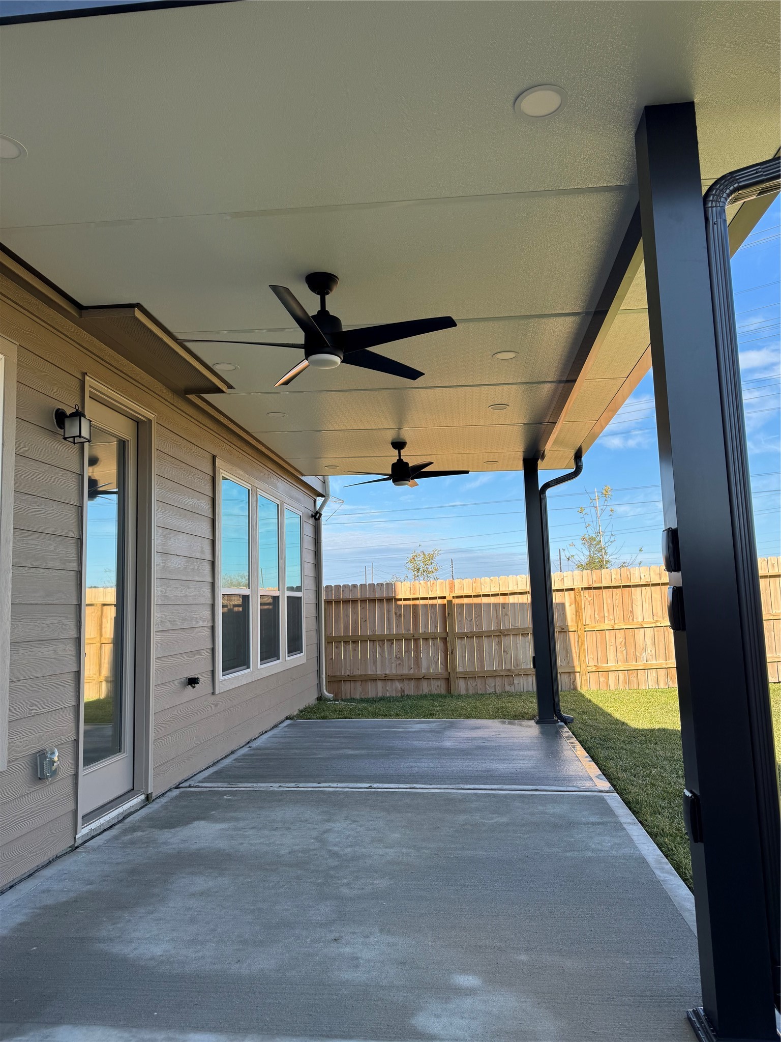 6415 Kentfield Drive Rosharon, TX 77583 - Photo 2 of 21 Custom 10' x 20' covered patio—perfect for outdoor entertaining and relaxing year-round.