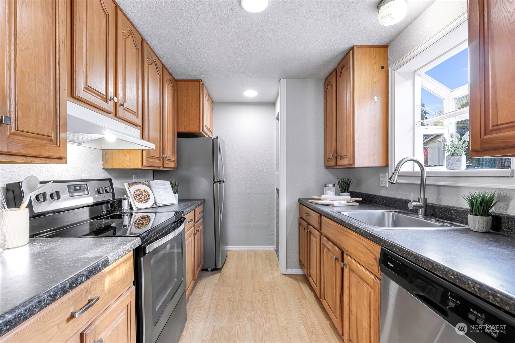 18216 22nd Drive Southeast Bothell, WA 98012 - Photo 18 of 40 a kitchen with a sink a stove cabinets and a window