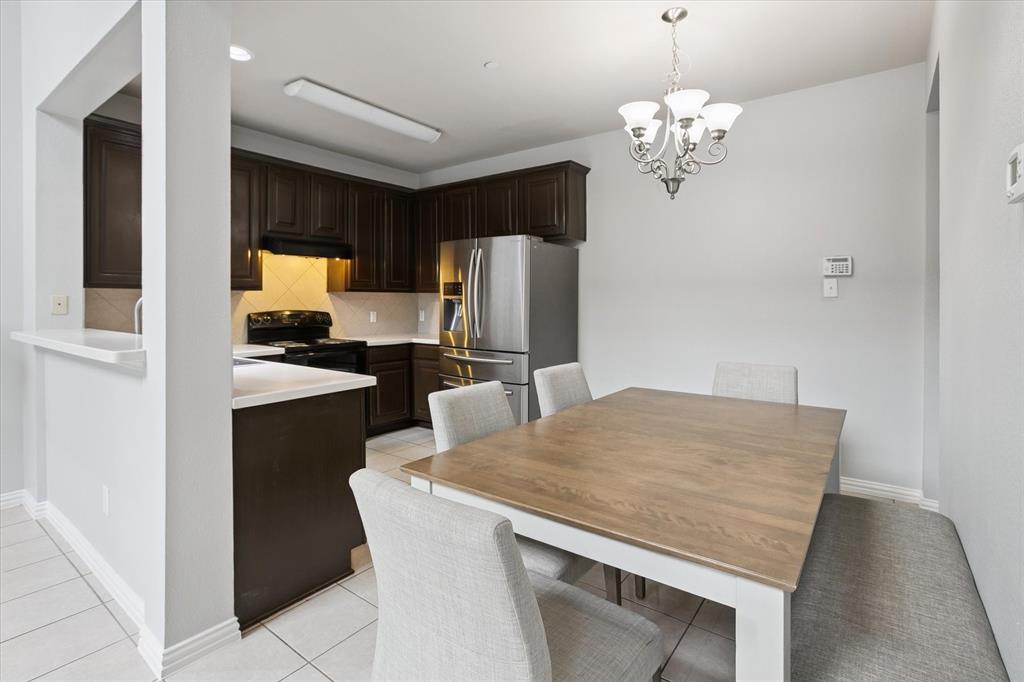 2202 Sandshell Street Bedford, TX 76021 - Photo 12 of 40 Dining room with light tile patterned floors and a chandelier