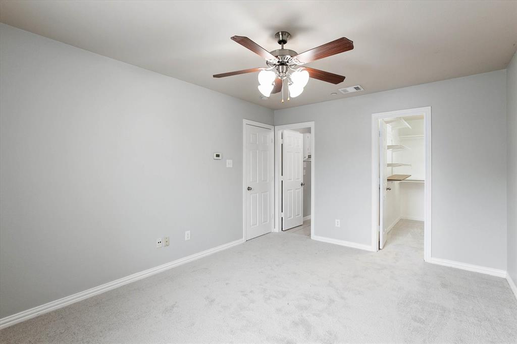 2202 Sandshell Street Bedford, TX 76021 - Photo 24 of 40 Unfurnished bedroom with light colored carpet, a spacious closet, and ceiling fan