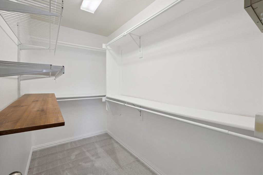 2202 Sandshell Street Bedford, TX 76021 - Photo 25 of 40 Walk in closet featuring light colored carpet