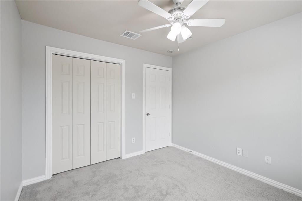 2202 Sandshell Street Bedford, TX 76021 - Photo 33 of 40 Unfurnished bedroom featuring carpet, a closet, and ceiling fan
