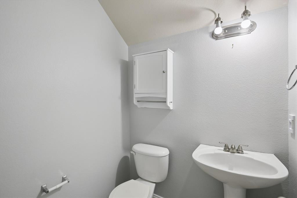 2202 Sandshell Street Bedford, TX 76021 - Photo 34 of 40 Half bath with toilet and a textured wall