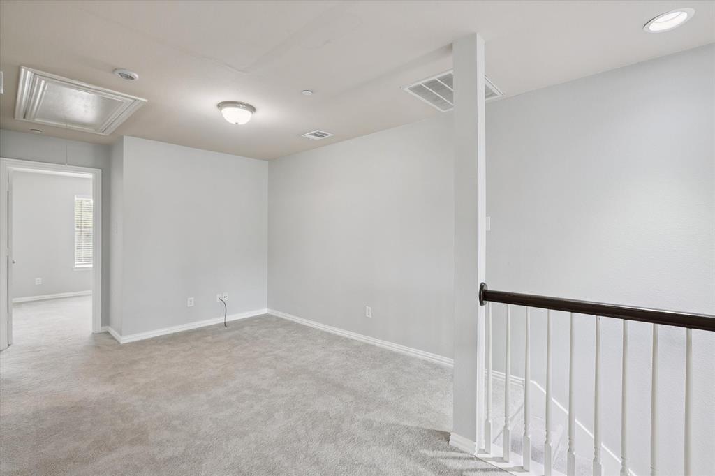 2202 Sandshell Street Bedford, TX 76021 - Photo 37 of 40 Empty room with attic access and light colored carpet