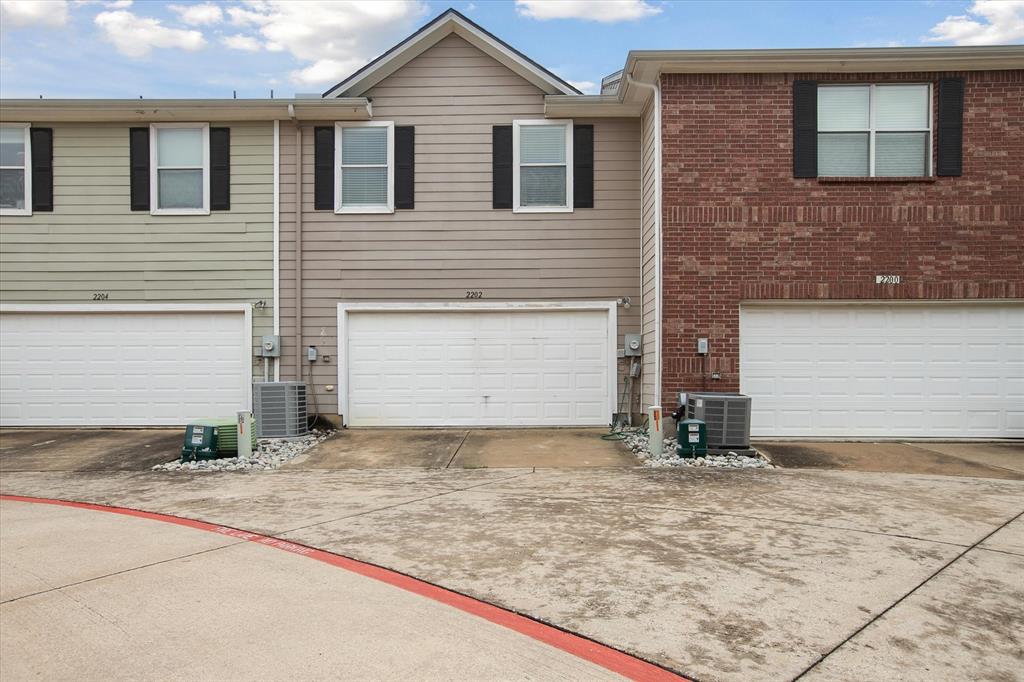 2202 Sandshell Street Bedford, TX 76021 - Photo 39 of 40 View of front of house featuring driveway, an attached garage, and brick siding