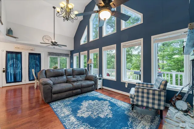 a kitchen with stainless steel appliances granite countertop a refrigerator a stove top oven a sink dishwasher and a refrigerator with wooden floor