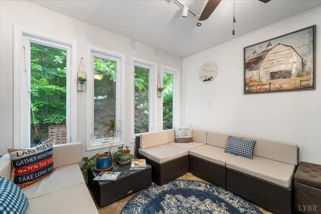 a living room with furniture and a floor to ceiling window