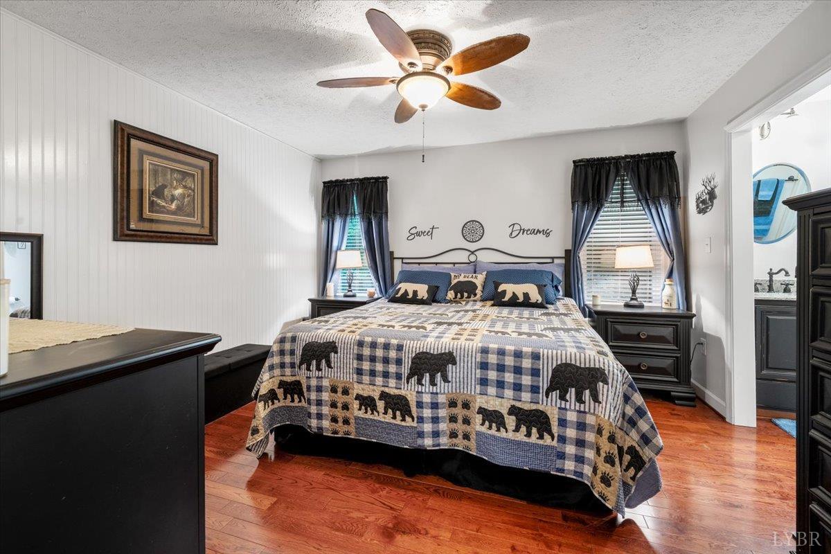 1765 Heron Pointe Drive Gretna, VA 24557 - Photo 21 of 64 a bedroom with a bed a dresser and potted plant