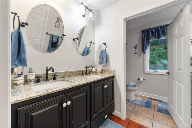 a bathroom with a sink toilet and mirror