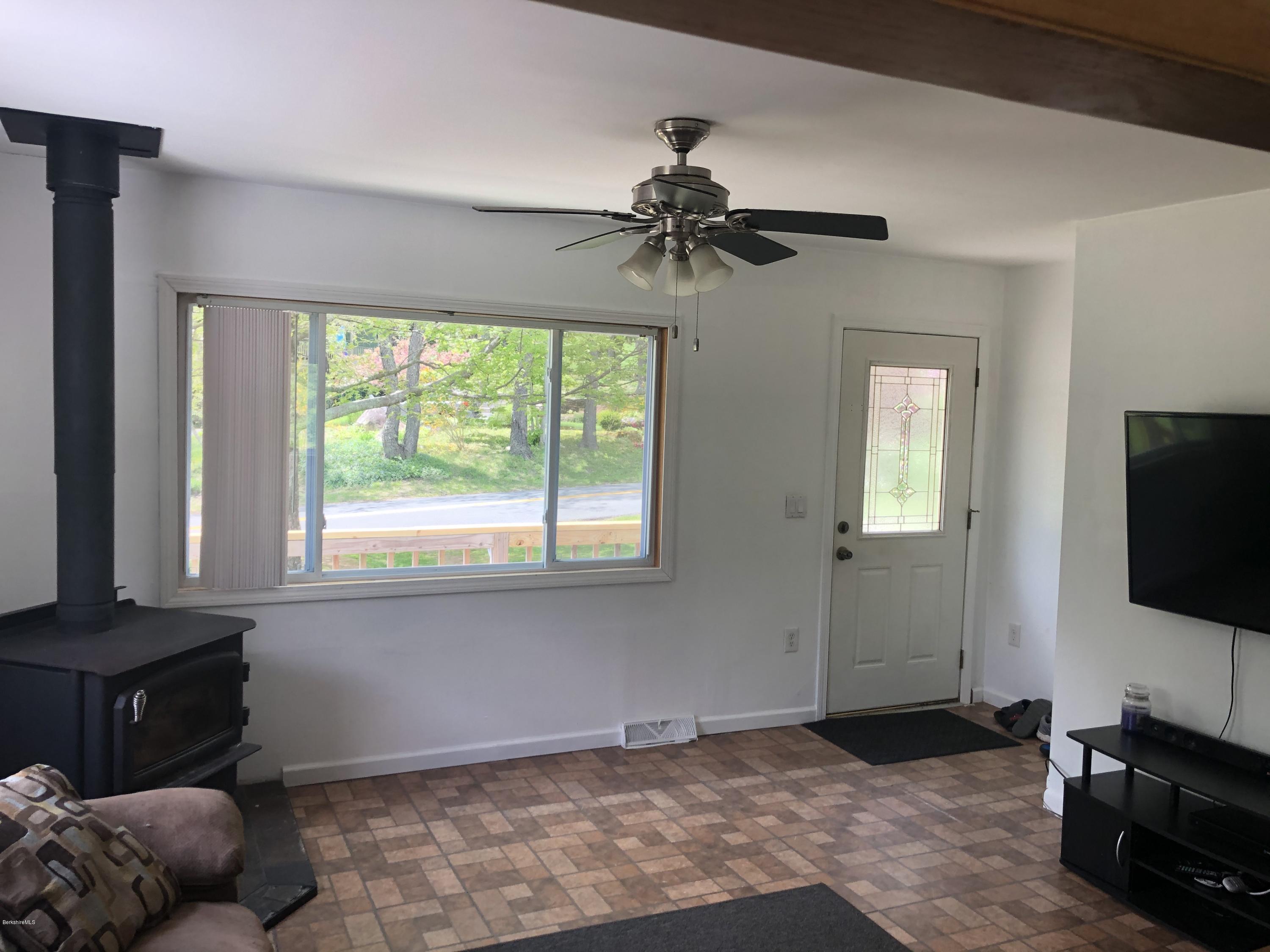218 Upper Valley Road Washington, MA 01223 - Photo 11 of 33 a living room with furniture and a flat screen tv