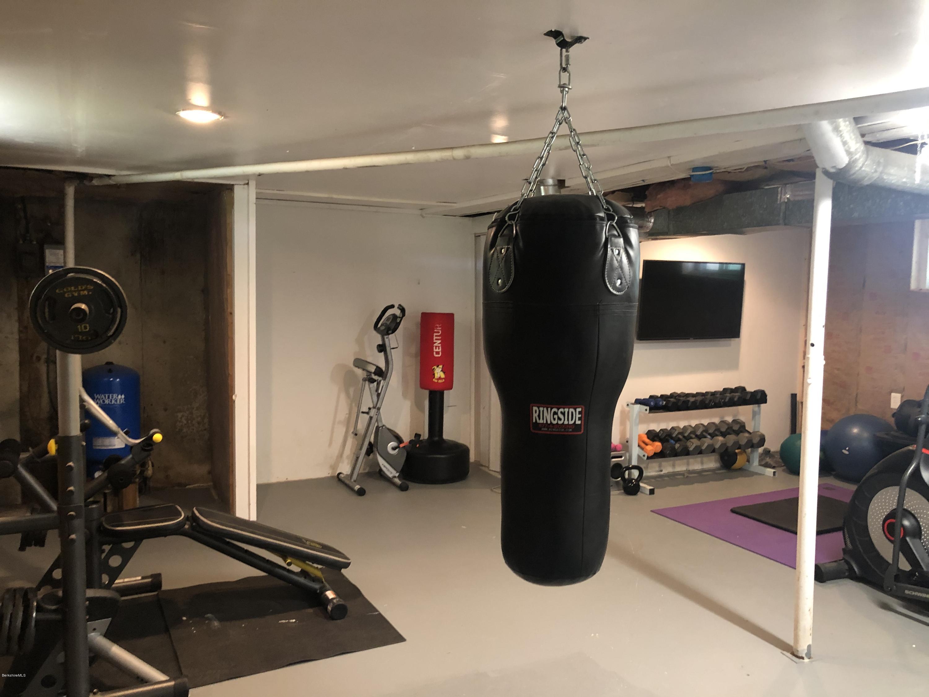 218 Upper Valley Road Washington, MA 01223 - Photo 24 of 33 a room with gym equipment and mirror