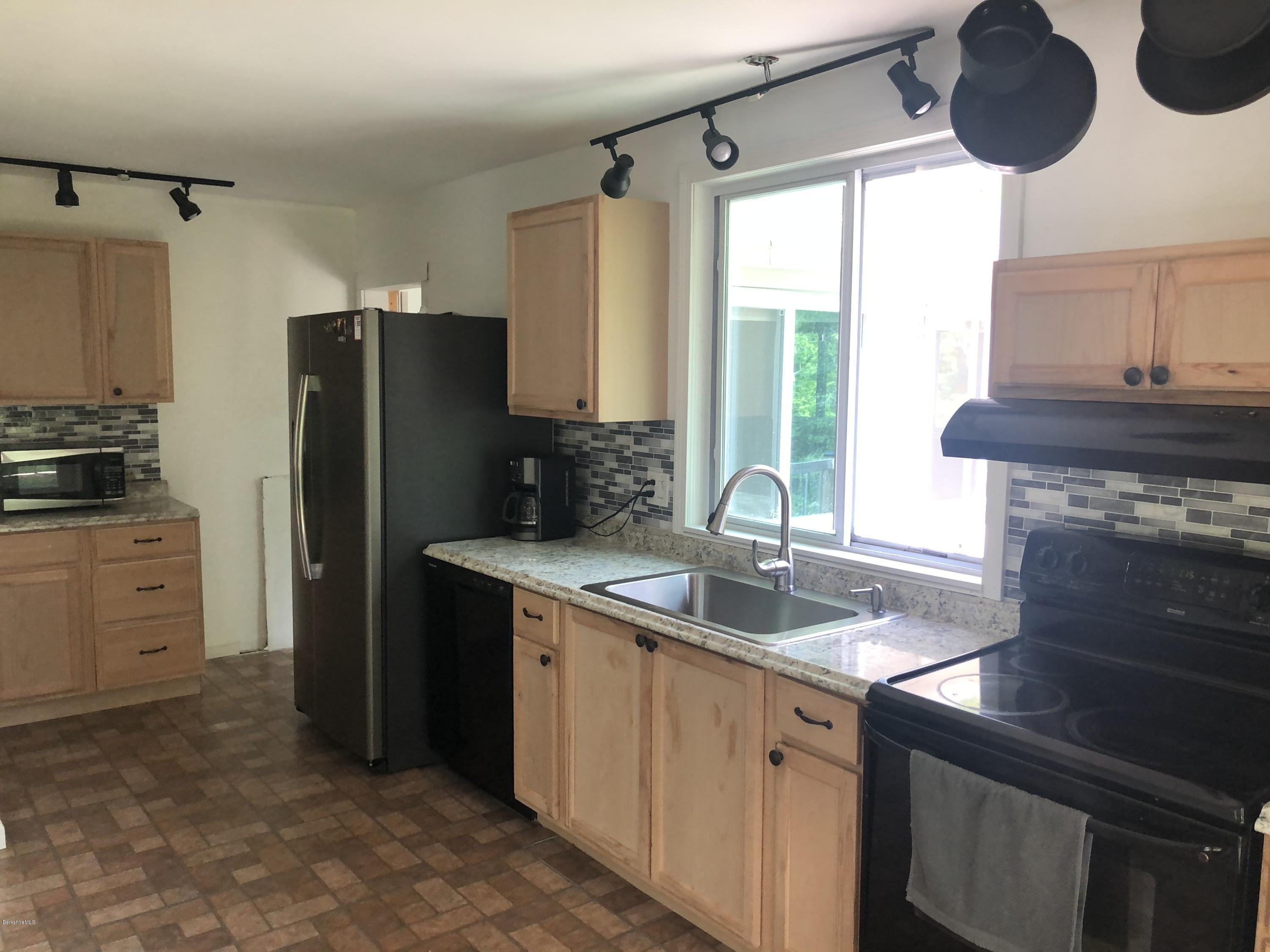 218 Upper Valley Road Washington, MA 01223 - Photo 6 of 33 a kitchen with a sink stainless steel appliances a window and a counter space