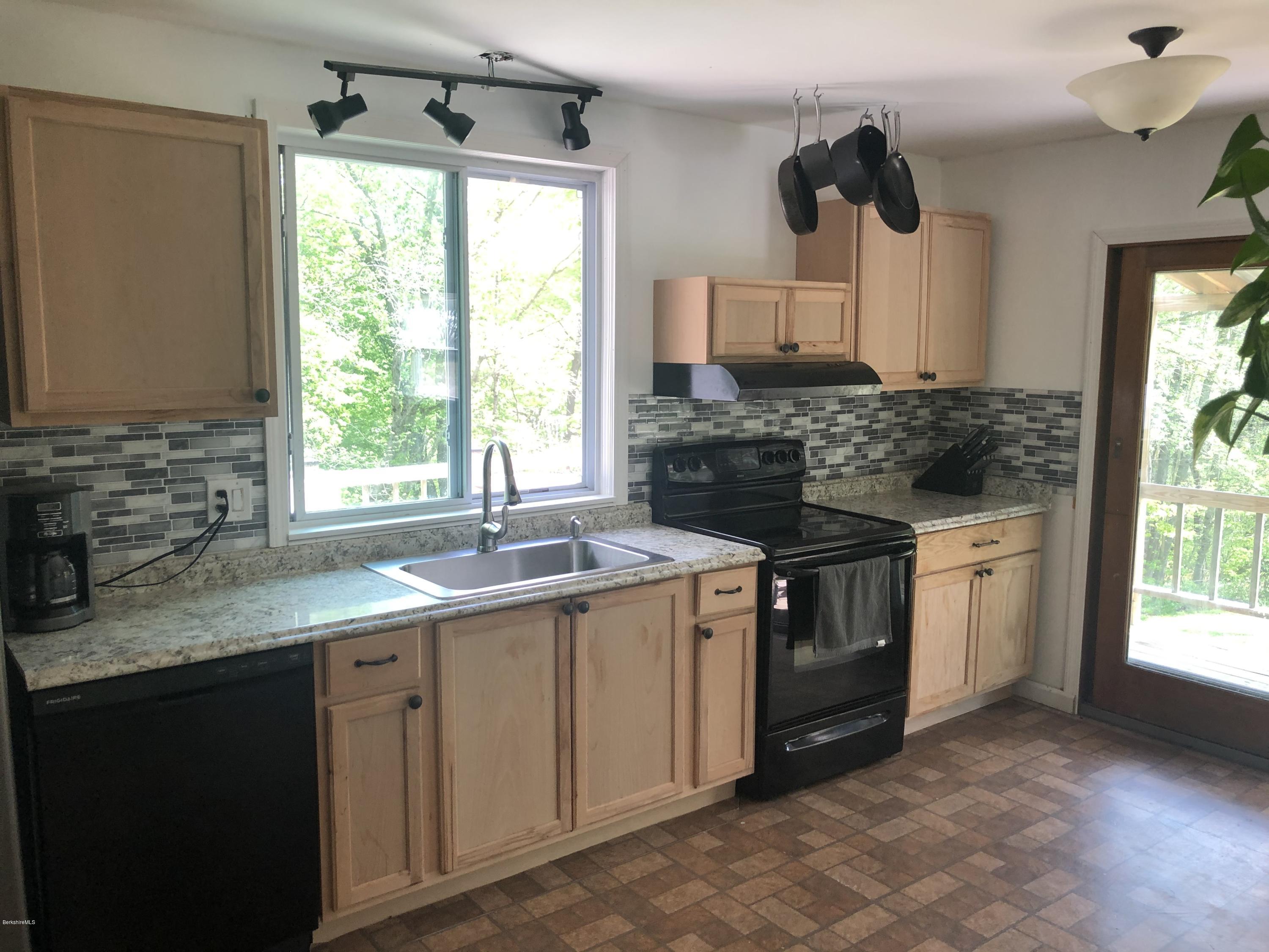 218 Upper Valley Road Washington, MA 01223 - Photo 8 of 33 a kitchen with a sink stove and cabinets
