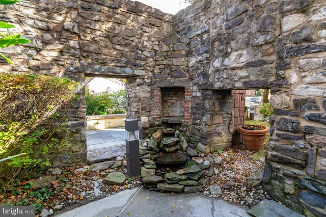 a kitchen with stainless steel appliances granite countertop a sink a stove and a wooden cabinets
