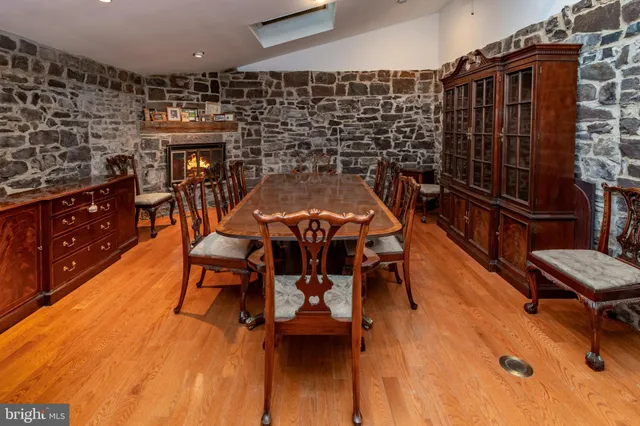 a view of an empty room and chandelier fan