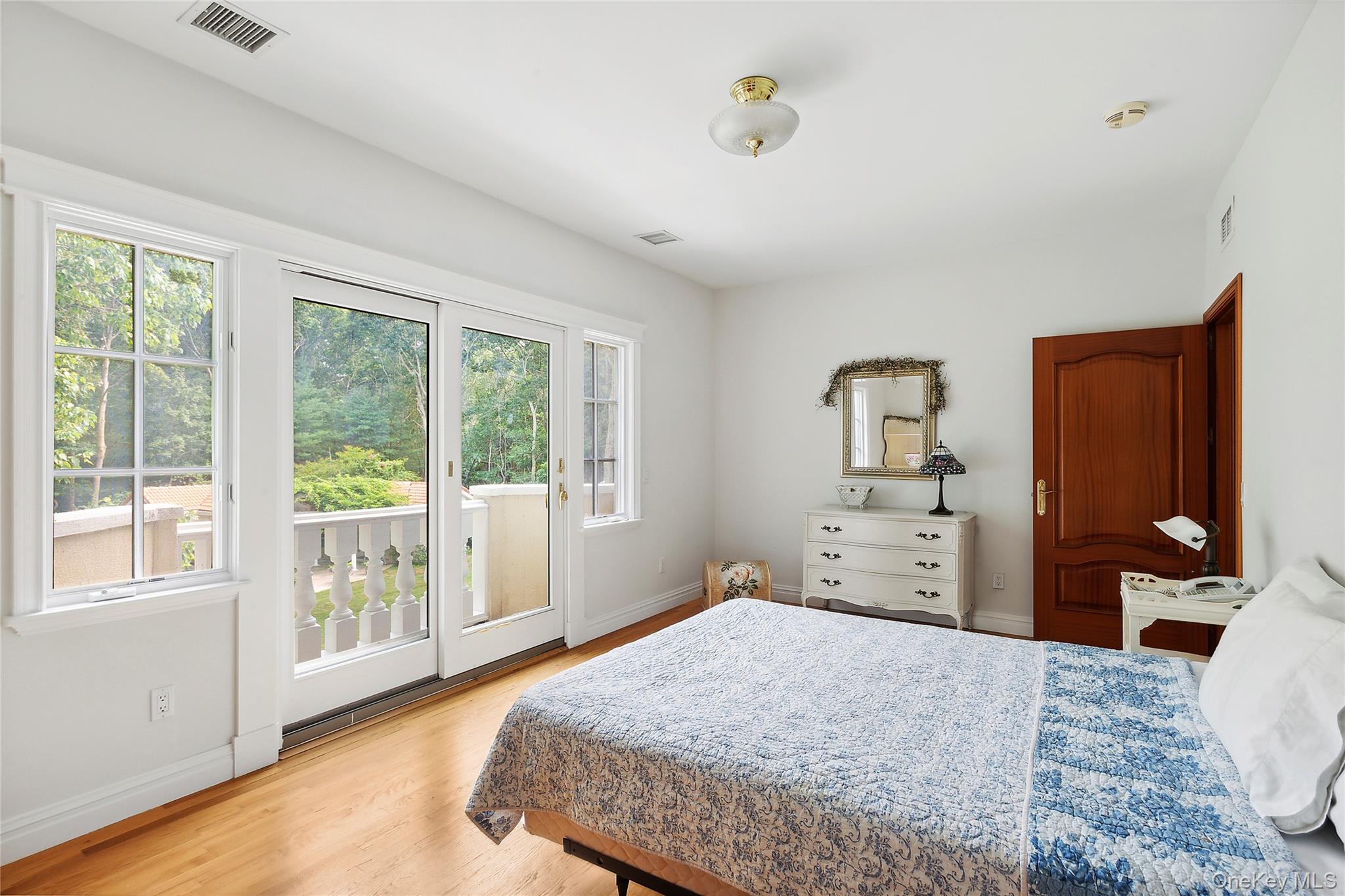 1 Terrys Trail East Hampton, NY 11937 - Photo 13 of 25 Bedroom with access to exterior and light wood-style floors