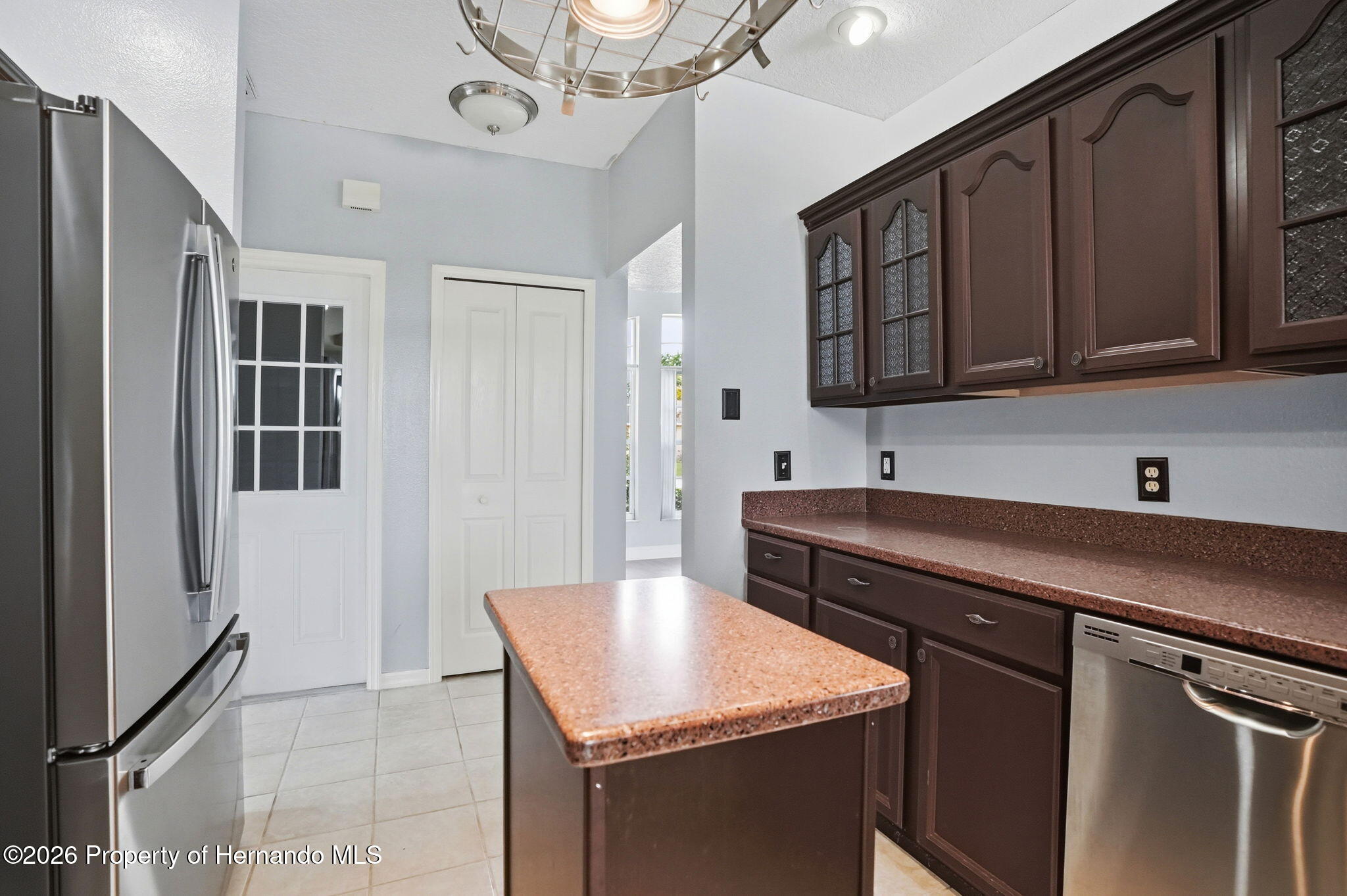 18131 Rivard Boulevard Brooksville, FL 34604 - Photo 14 of 66 a kitchen with a sink cabinets and wooden floor