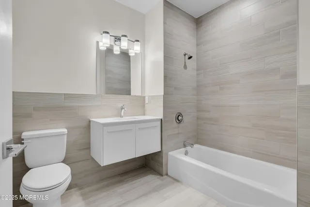 a bathroom with a sink a toilet and bathtub