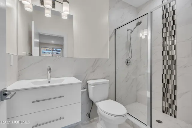 a bathroom with a sink toilet and shower