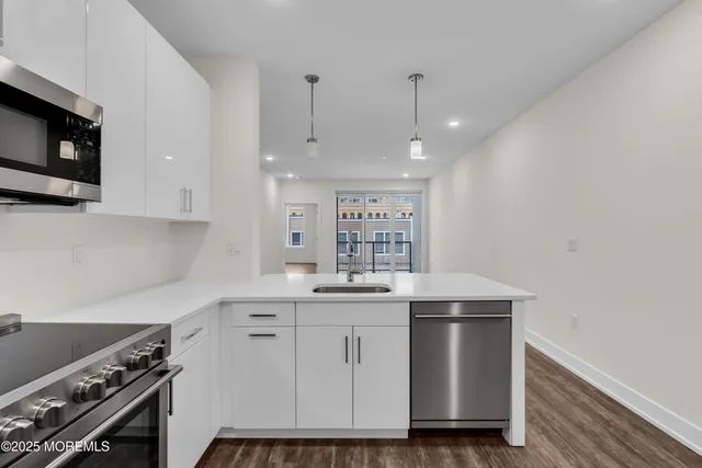 a kitchen with a sink stove and cabinets