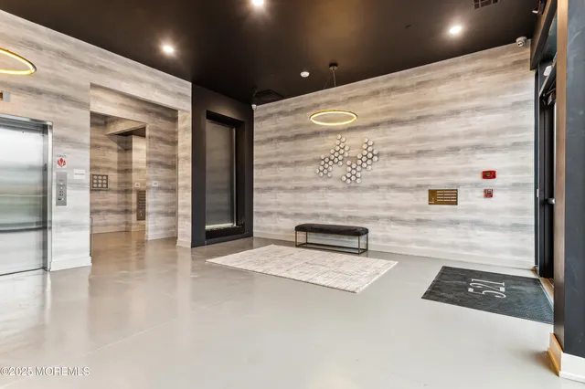 a view of a hallway with wooden floor and chair