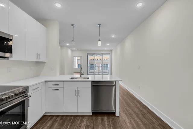 a kitchen with a sink stove and cabinets