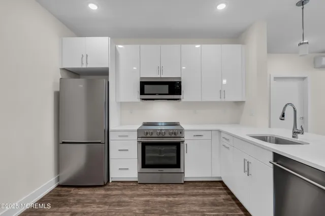 a kitchen with a sink a stove and refrigerator