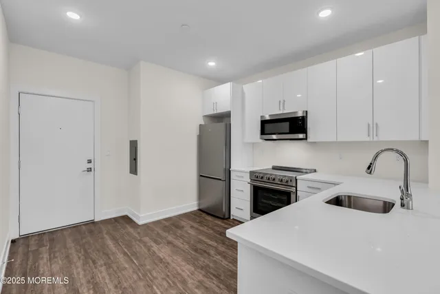 a kitchen with a sink a stove and refrigerator