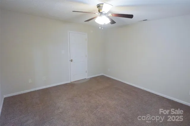 a view of an empty room with a fan