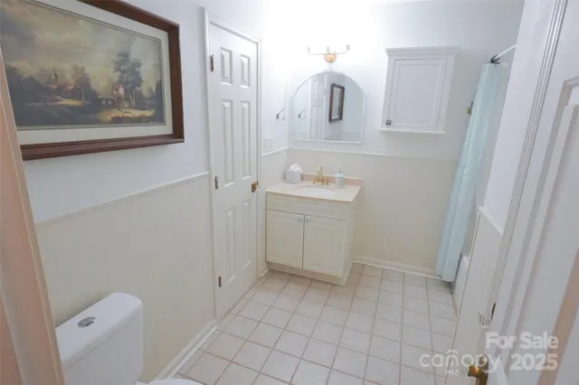 a bathroom with a sink a toilet and vanity