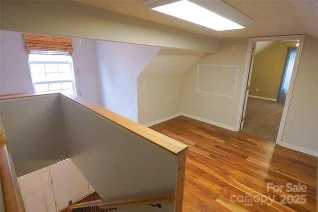 a view of a room with wooden floor