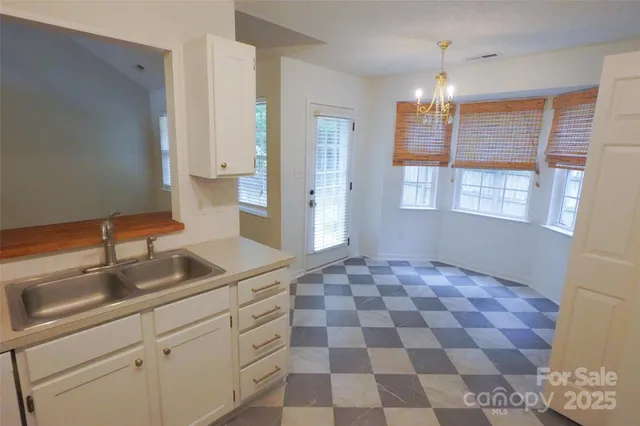 a kitchen with a sink a refrigerator and cabinets