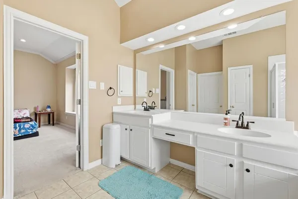 a spacious bathroom with a double vanity sink mirror and