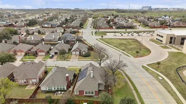 an aerial view of residential houses with outdoor space